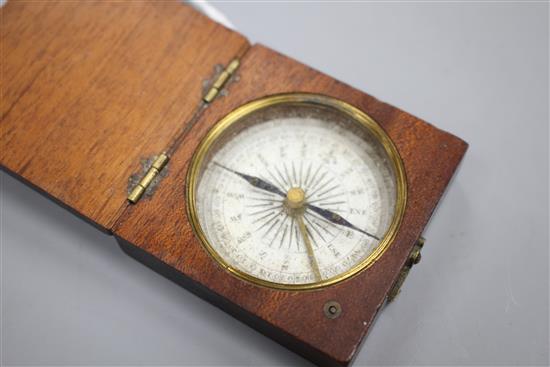 An early 19th century mahogany cased pocket compass, the dial marked in quadrants of ten degree divisions, the case 5cms sq.